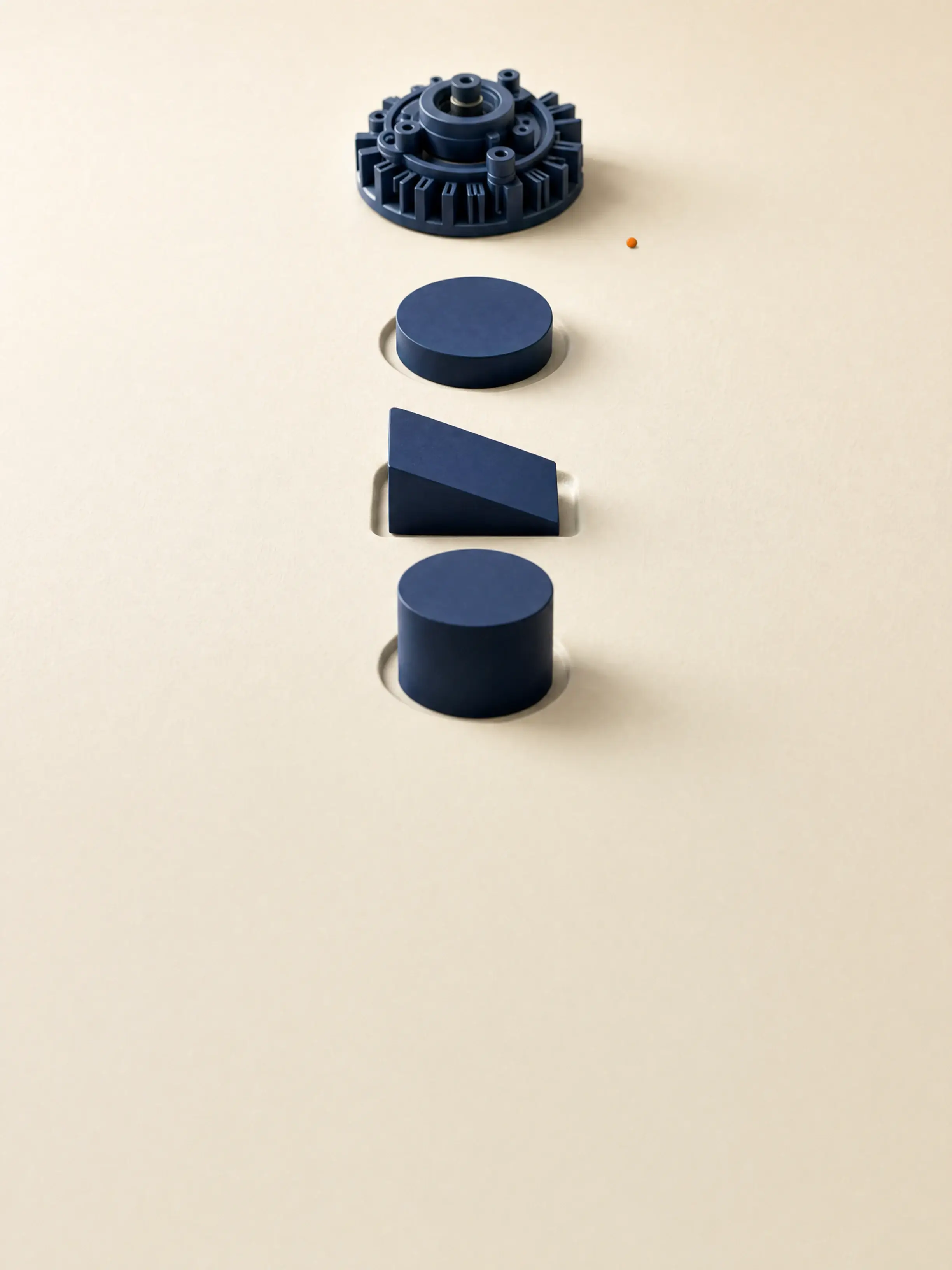 Three plain navy forms each rest in a clean recess pressed into an ivory surface, while a far more elaborate fourth object stands on unbroken ground beside a single orange point.